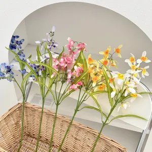 Multi-colored artificial orchid stems in a wicker basket for home decor