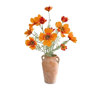 Realistic 4-head orange artificial cosmos flowers in a rustic terracotta vase for home.