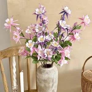 Detailed view of artificial columbine flowers in a ceramic vase for home decoration