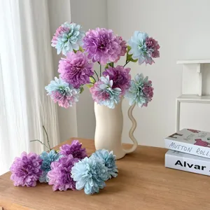 Elegant close-up of purple and blue artificial dahlia flowers in a modern white vase