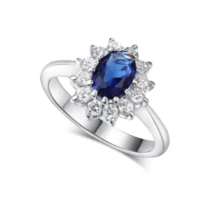 Elegant silver ring featuring an oval blue sapphire center stone and clear zircon halo