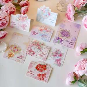 Assorted 3D floral bouquet greeting cards with English blessings on a flatlay setup