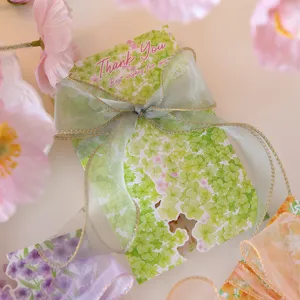 Close-up of floral thank you gift card decorated with an elegant green organza ribbon bow