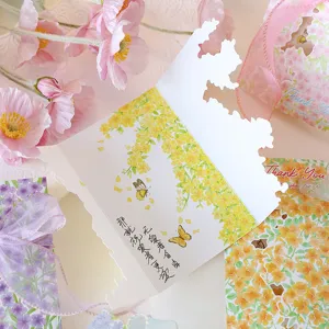 Detailed view of an elegant floral greeting card with unique die-cut edges and ribbon