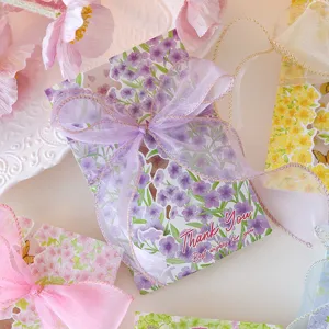 Macro detail view of floral thank you greeting cards with elegant purple organza ribbons