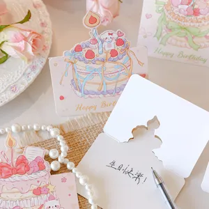 Detail of cute 3D birthday card featuring a strawberry cake illustration with a writing pen.