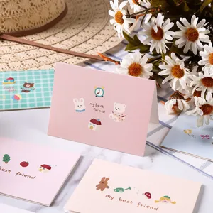 Detail of cartoon animal greeting cards with 'my best friend' text on marble table