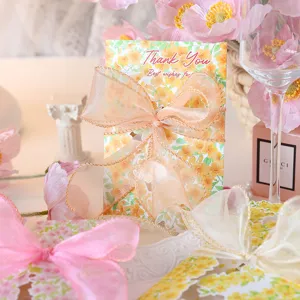 Detailed close-up of a floral greeting card decorated with an elegant organza ribbon bow