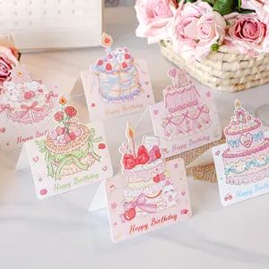 Detailed view of 3D pop-up birthday cards with cute cake and animal illustrations