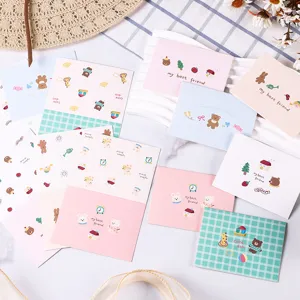Detail shot of pastel greeting cards featuring cute cartoon animal illustrations and message