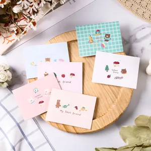 Detailed macro view of cute cartoon animal illustration message cards on a wooden tray