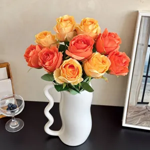 Elegant artificial Bulgarian roses in white wavy ceramic vase for home and wedding decoration