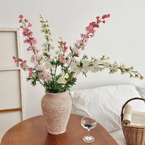Three-forked artificial delphinium silk flowers in a rustic vase for elegant home decor