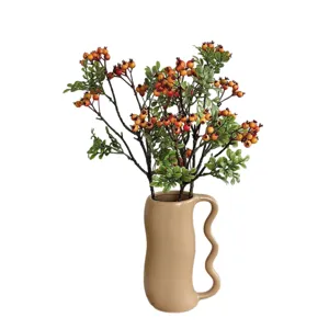 Artificial red berry branches in a beige wavy handle ceramic vase for home decor