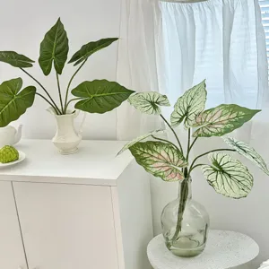 Close-up of realistic 3D printed artificial Alocasia and Caladium leaves for home decor