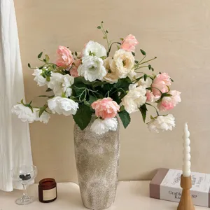 Elegant pink and white artificial peony arrangement in a tall textured ceramic vase