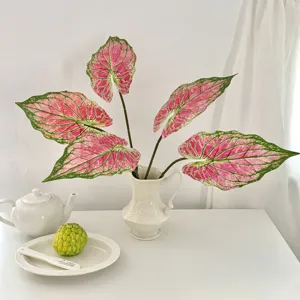 Detailed view of 3D printed pink Caladium leaves in a white vase for home decor.