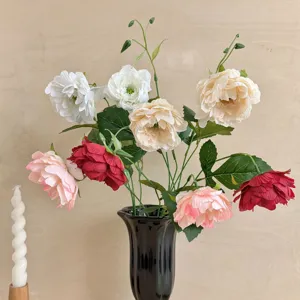 Elegant multi-colored artificial peony flowers in a sleek black vase for home decor