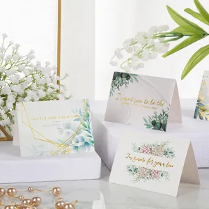 Vista detallada de tarjetas de felicitación florales con elegantes letras en oro