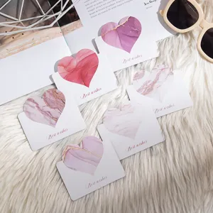Close-up of marble pattern heart greeting cards with Best wishes text