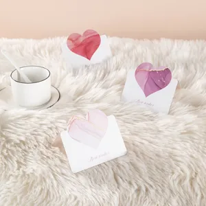 Close-up detail of creative heart-shaped greeting cards with elegant marble patterns