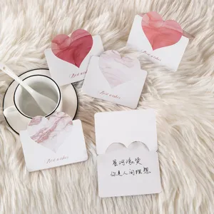 Detailed close-up of heart-shaped greeting cards on a white plush rug for festivals