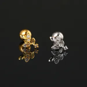 Detailed view of floral zircon stud earrings with gold and silver finishes