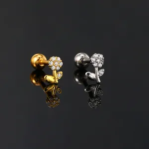 Detailed close-up of tiny flower cartilage studs with micro-paved sparkling zircons