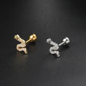 Close-up view of elegant snake-shaped cartilage stud earrings in gold and silver finishes