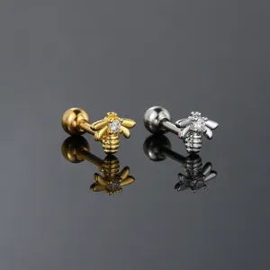 Detailed macro shot of golden and silver bee stud earrings with clear zircon stones