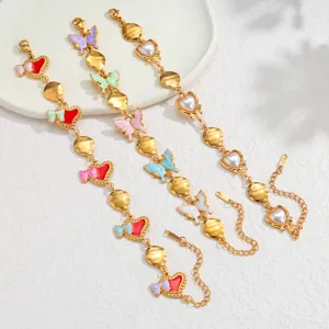 Detailed view of three French style enamel butterfly and heart bracelets in 18k gold finish