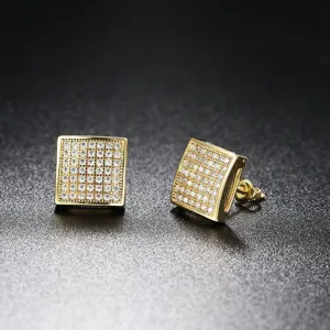 Macro detail of square gold-plated hip-hop stud earrings with pave cubic zirconia stones