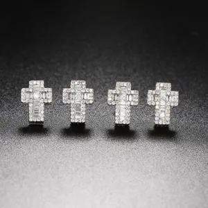Macro shot of four hip-hop cross stud earrings with sparkling micro-paved cubic zirconia.