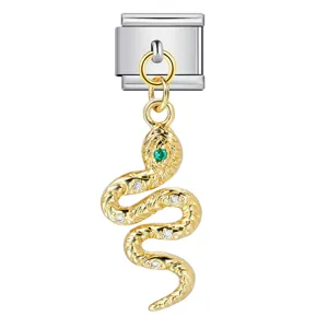 Detailed view of a gold snake charm with green eye for Italian modular bracelets