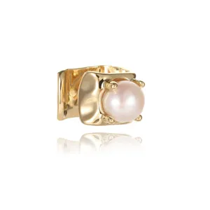 Detailed view of a minimalist gold square ear cuff featuring a glossy white pearl
