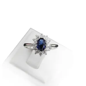 Elegant silver ring with a large oval dark blue stone and sparkling halo of zircons