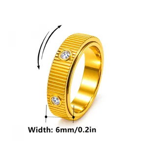 Close-up detail of 6mm wide gold ribbed spinner ring featuring embedded sparkling crystals