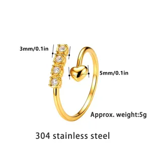 Macro detail of gold 304 stainless steel open ring with heart and clear cz stones