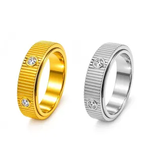 Elegant spinning rings in gold and silver with vertical ribbing and crystal accents