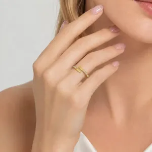 Detailed close-up showing the crystal accents on a gold stainless steel wrap ring.
