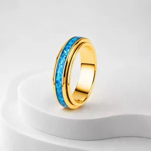 Elegant gold stainless steel spinner ring with vibrant blue opal inlay for couples