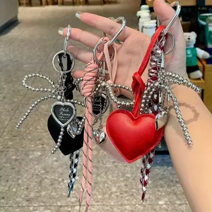 Heart-shaped beaded bow keychain and bag charm, stylish multi-color leather heart accessory.