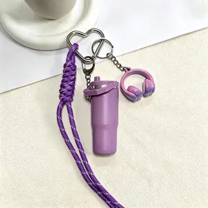 Purple mini tumbler water bottle keychain with woven lanyard and headphone pendant detail.