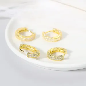 Close-up view of shiny gold-plated micro-paved cubic zirconia hoop earrings detail shot.