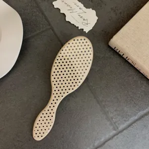Beige polka dot hairbrush with cushion massage bristles for smooth hair styling