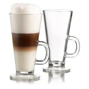 Close-up detail of clear glass latte cups with handles, showing clean transparent design.