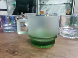 Green frosted glass coffee mug detail, minimalist design cup with handle for home use.