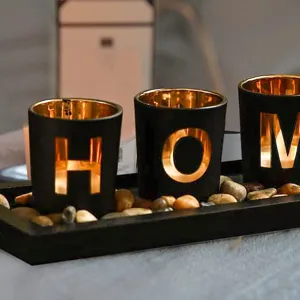 Handcrafted glass candle holder set with decorative stones for romantic home decor and aromatherapy.