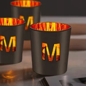 Creative handmade glass candle holder with letter M cutout design, romantic home decor jar.