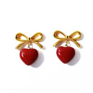 Elegant retro stainless steel gold bowknot earrings featuring red oil-drop heart pendants